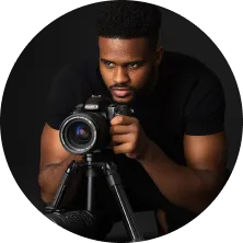 A man holding a camera in front of him.