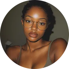 A woman wearing glasses and a grey tank top.