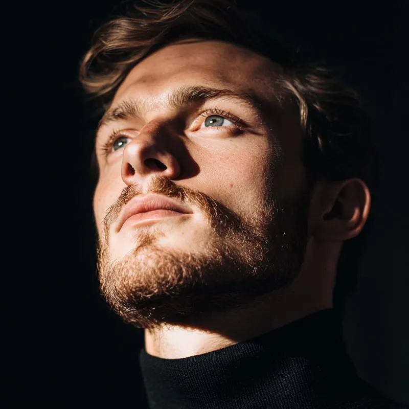 A close up of a man with a beard.